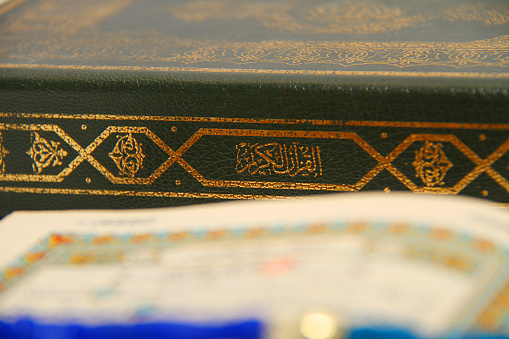 close-up of holy book Quran, sunlight is reflected to Quran