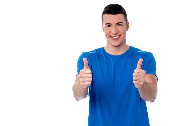 istock Young smiling man showing thumbs up 519849495