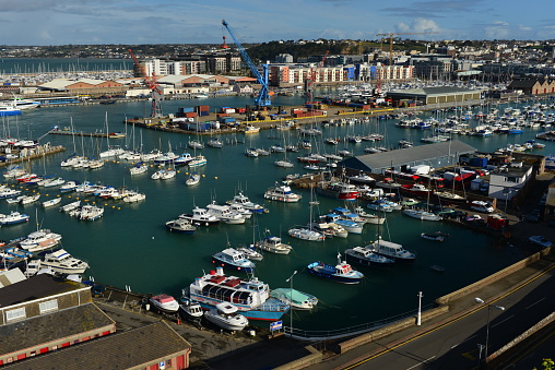 Jersey, U.K. - April 9, 2016: St.Helier harbour and marina with a small docks full of local yachts,motorboats and fishing boats on a very high 12m Spring tide.
