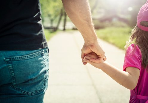 Father And Daughter Walking And Holding Hands In Park Stock Photo -  Download Image Now - iStock