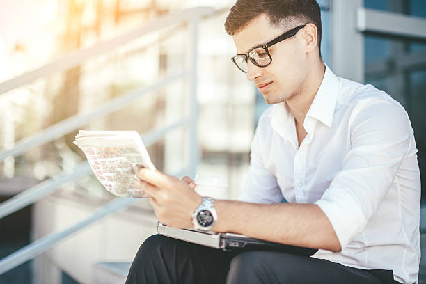 istock Businessman reading newspaper 519862902