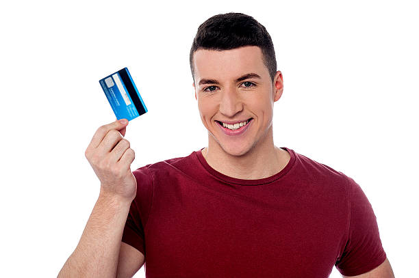 istock Young man holding credit card 519863039