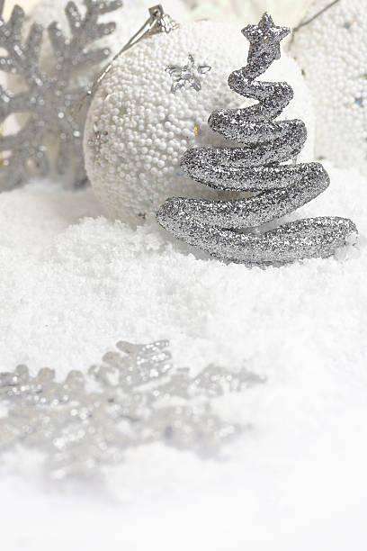istock Christmas ornaments on white snowy background 519863605