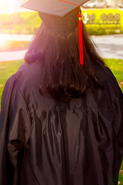 Maroon academic mortarboard with golden tassel. Graduation in arts, humanities and related disciplines. 3D rendering isolated on white background