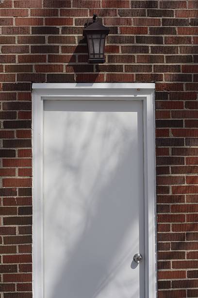 istock White door on a brick house 519865214