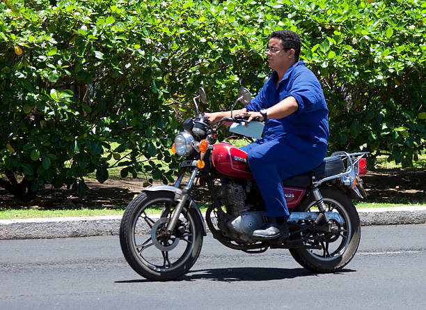salvador, bahia, brazil - august 11, 2023: motorcycle rider seen transiting along an avenue in the city of Salvador.