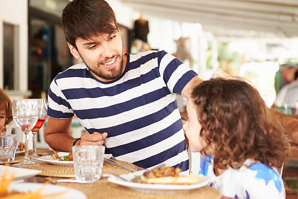istock Father And Daughter Enjoying Meal In Restaurant 519866225