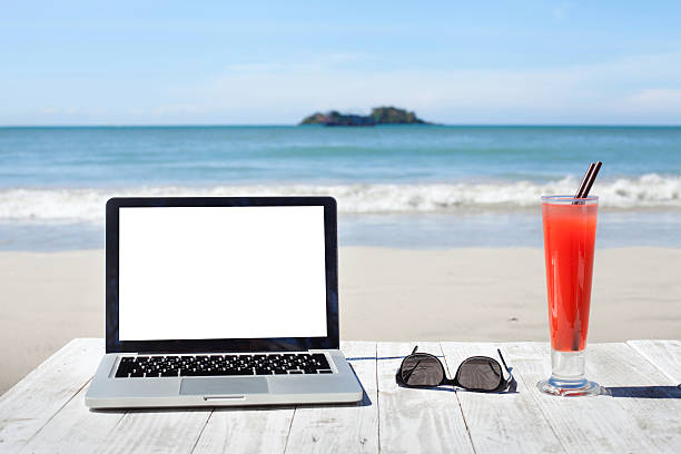 istock office workplace on the beach, laptop and cocktail 519866782