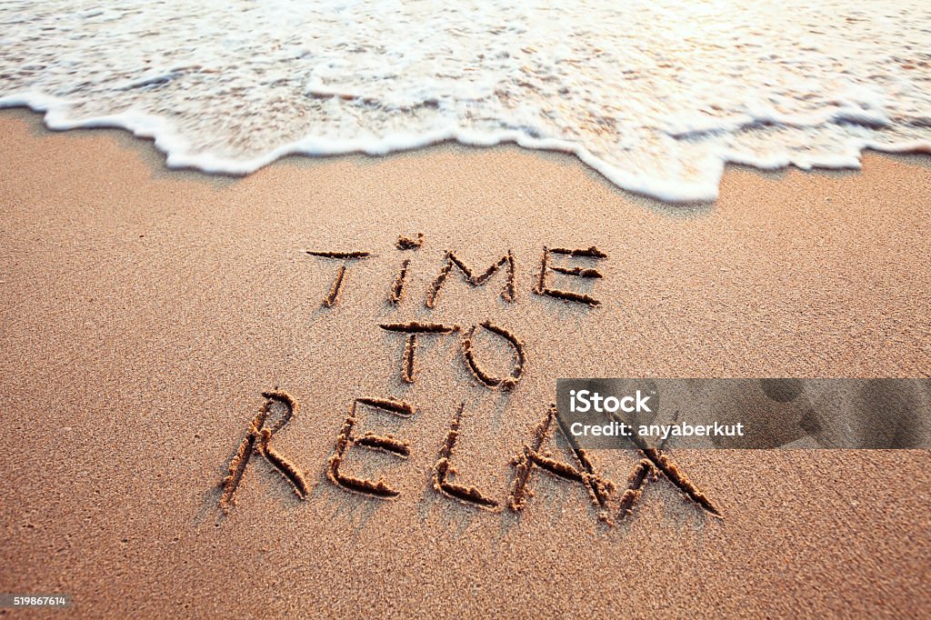 time to relax time to relax, concept written on sandy beach Relaxation Stock Photo