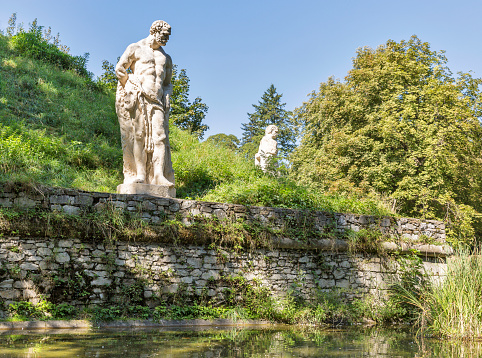 Antique statues along pool in Stadt park in Graz, Austria