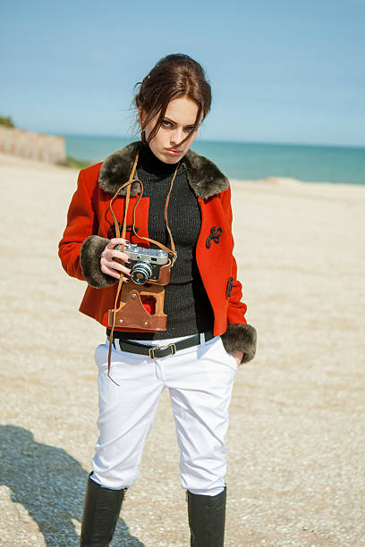 Beach woman with vintage retro camera