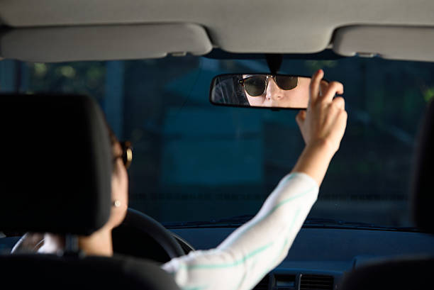 istock woman adjusting rear mirror 519870242
