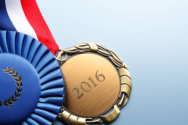 istock Gold Medal Engraved With 2016 Next To A  Blue Ribbon 519871076