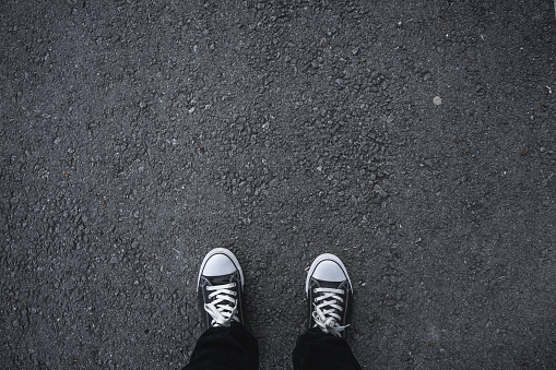 Canvas shoes on asphalt.