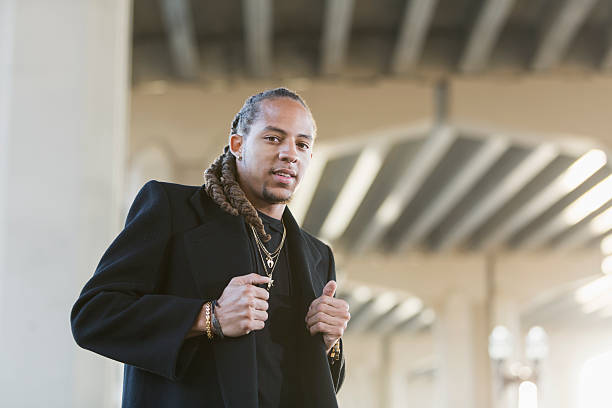 istock Young mixed race man wearing black coat 519874006