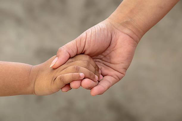 istock Woman and baby hands 519874680