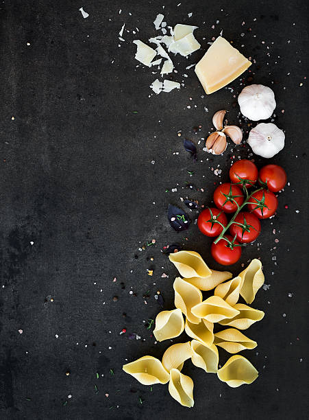 istock Food frame. Pasta ingredients. Cherry-tomatoes, pasta, garlic, basil, parmesan 519875460