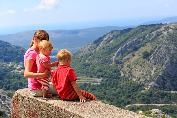 istock mother with kids looking at scenic view in mountains 519884859