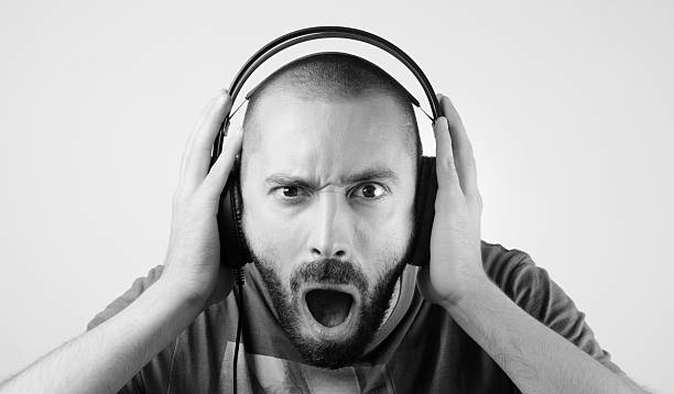 istock Man with headphones screaming 519887257