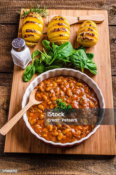 Spicy Cowboy Beans With Hassleback Potatoe With Herbs Stock Photo - Download Image Now