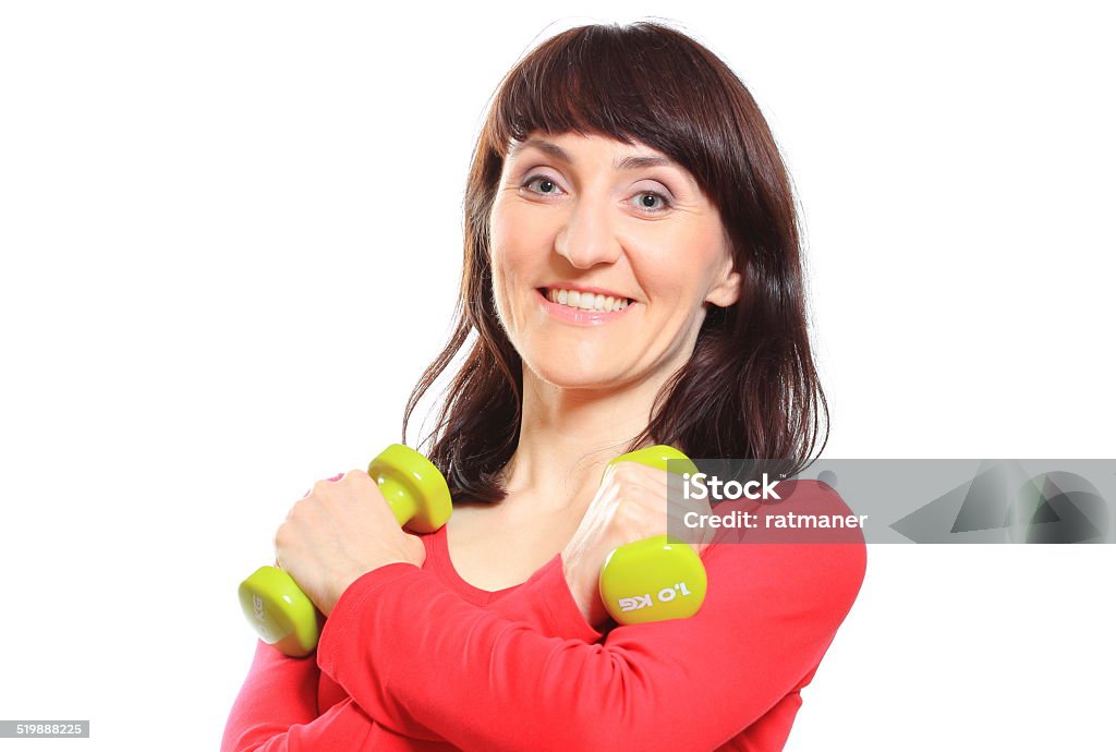 Bellissimo brunette durante fitness esercizi con manubri - Foto stock royalty-free di Adulto