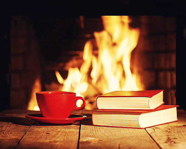 istock Red cup of tea or coffee and old books 519889000