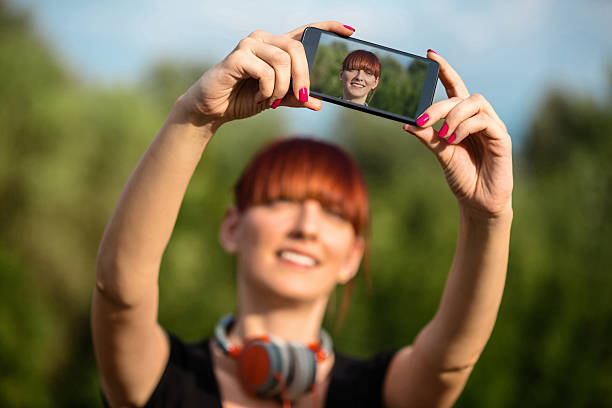 istock Young Woman Taking Selfie 519889099