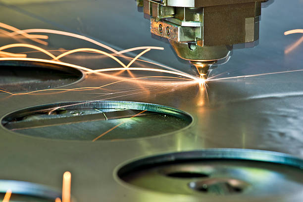 Laser/plasma CNC metal-cutter in operation A CNC laser metal cutting tool in operation. Plasma or laser cutting tools are used to cut metals with precision at high speeds. Note, ghosting and motion blur due very high velocity of movement. laser cutting metal stock pictures, royalty-free photos & images