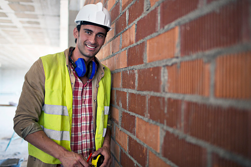 Portrait of a builder in the construction site.