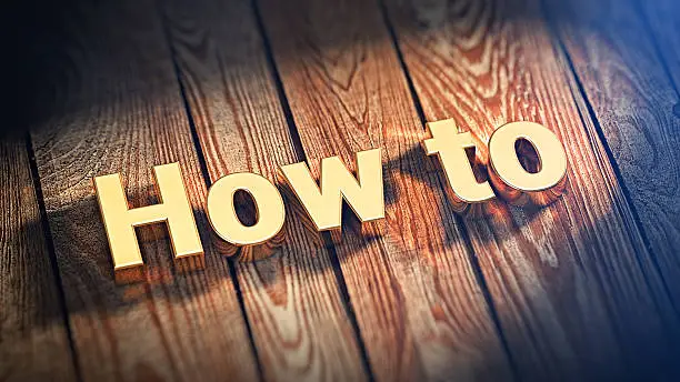 The word "How To" is lined with gold letters on wooden planks. 3D illustration picture