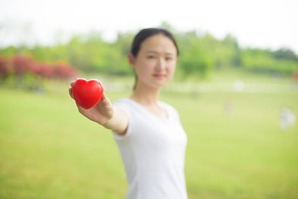 istock smiling little girl with red heart 519895376