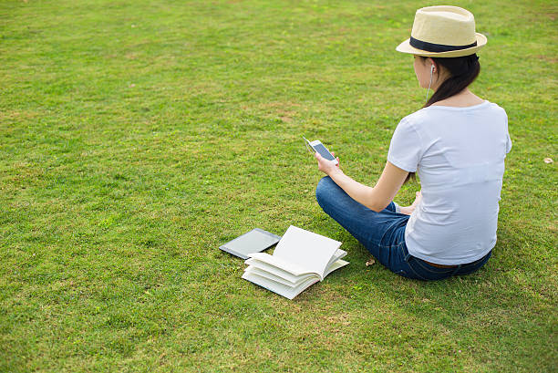 istock Girl on the grass with a cell phone 519897618