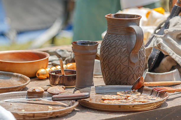 Photo shows close-up of medieval kitchen table during a day.