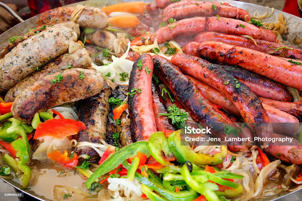 Steaming Sausages Brats, weiners and vegetables steam away in a large round pot at a festival. Agriculture Stock Photo