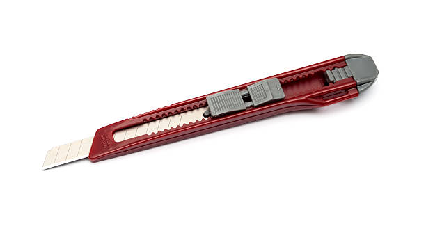 istock Red paper knife isolated on white background 519911427