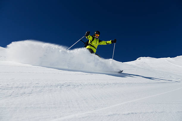 istock Alpine skier on piste, skiing downhill 519912841