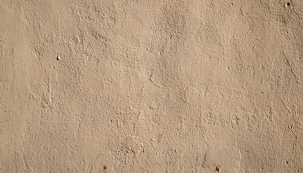 istock Texture of old  wall covered with yellow stucco 519913931