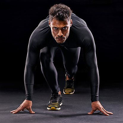 Studio shot of a focussed athlete in the starting position