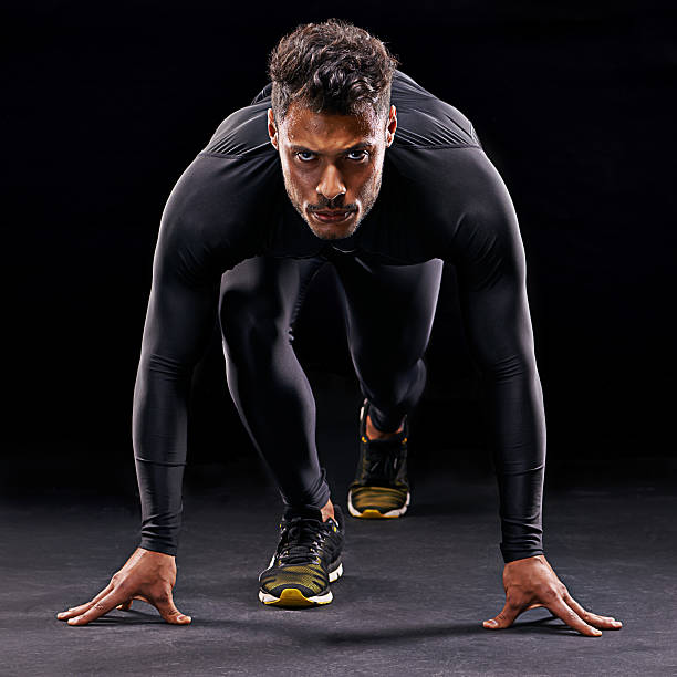 Get set... Studio shot of a focussed athlete in the starting position spandex stock pictures, royalty-free photos & images