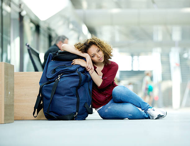 istock Tired young woman resting on bag 519917449