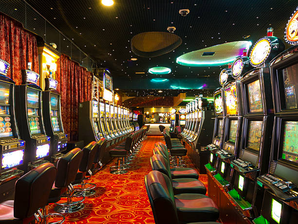 Casino at wait A Slot machines room in an empty  Casino just before the opening time. coin operated stock pictures, royalty-free photos & images