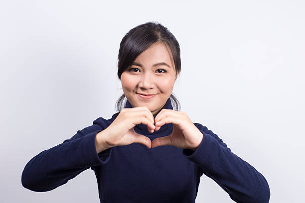 istock Woman in love and make heart shape by hands 519919942