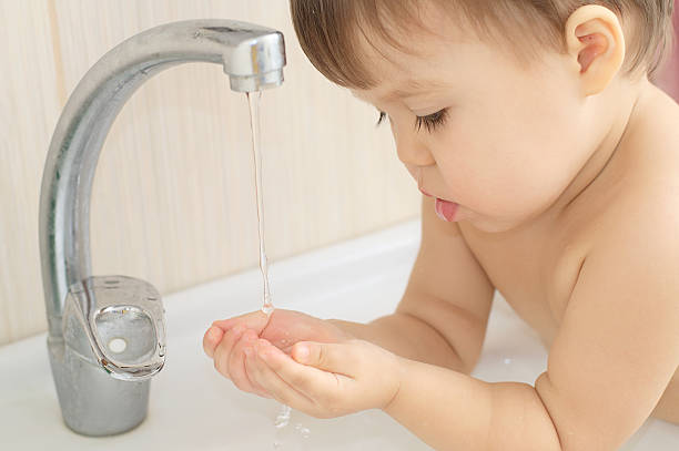 istock Baby child gather water in palms 519920572
