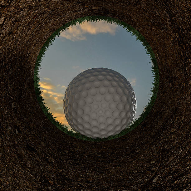 istock 3D illustration of a golf ball going into a hole. 519920776