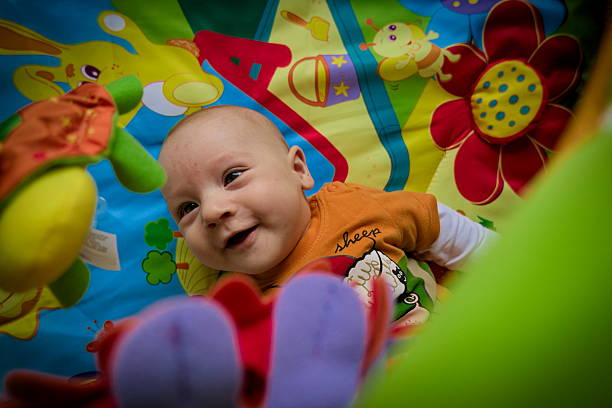 istock Happy smiling baby boy playing in colorful playpen 519921748