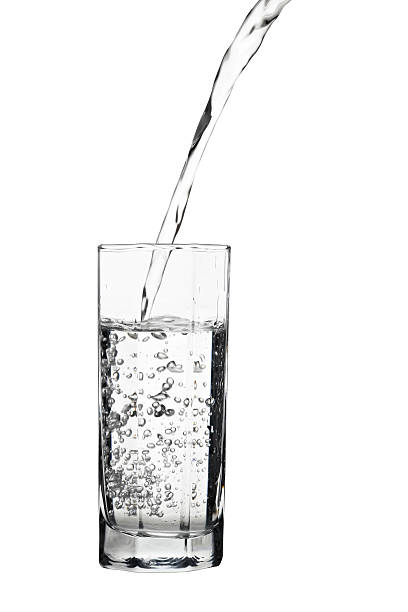 istock Water pouring into glass, air bubbles in the water 519922354