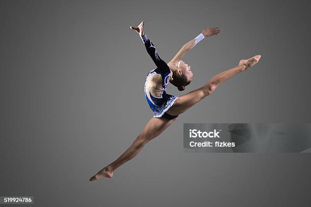 Gymnast Girl Doing Splits In The Air Stock Photo - Download Image Now - Gymnastics, Gym, Teenager