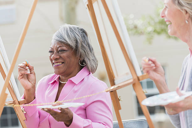 istock Two senior women having fun painting in art class 519926714