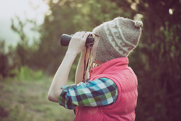 istock Hiker looking in binoculars enjoying view in forest 519926940
