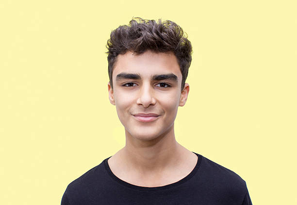 istock Portrait of smiling boy over yellow background 519929494